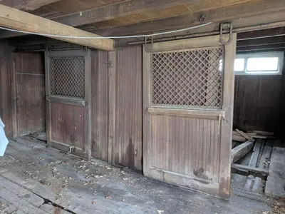 an old wooden barn with two doors and a window at Historic Barn - 2 Bedroom Apartment Close To Legoland NY in Goshen