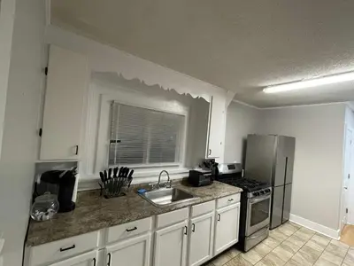 a kitchen with a sink and a stove at Beach Apartment in Woodmont Milford 102 in Milford