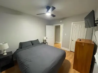 a bedroom with a bed and a ceiling fan at Beach Apartment in Woodmont Milford 102 in Milford