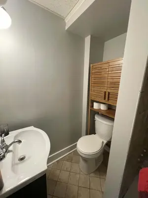 a bathroom with a white toilet and a sink at Beach Apartment in Woodmont Milford 102 in Milford