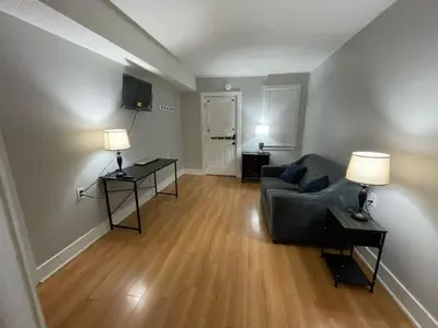 a living room with a couch and a table with lamps at Beach Apartment in Woodmont Milford 102 in Milford