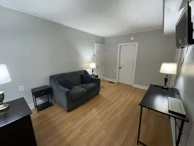 a living room with a couch and a table at Beach Apartment in Woodmont Milford 102 in Milford