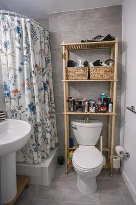 a bathroom with a toilet and a shower curtain at Chic West Village Studio on Bleecker Street in New York