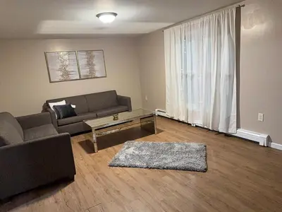 a living room with a couch and a coffee table at FOR LONGTERM RENTAL 3 BR NEAR YALE SCIENCE CENTER-MUNSON St in New Haven
