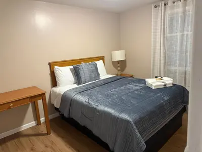 a bedroom with a large bed with a blue blanket at FOR LONGTERM RENTAL 3 BR NEAR YALE SCIENCE CENTER-MUNSON St in New Haven