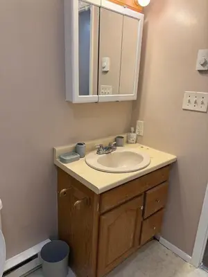 a bathroom with a sink and a mirror at FOR LONGTERM RENTAL 3 BR NEAR YALE SCIENCE CENTER-MUNSON St in New Haven