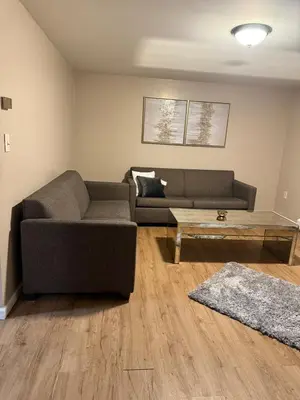 a living room with a couch and a coffee table at FOR LONGTERM RENTAL 3 BR NEAR YALE SCIENCE CENTER-MUNSON St in New Haven