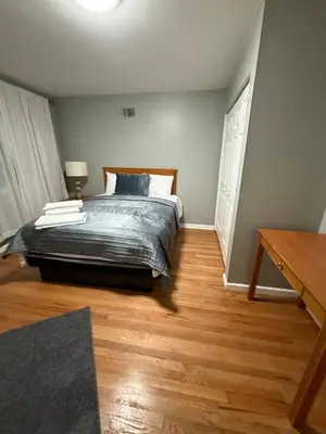a bedroom with a bed and a wooden floor at Barnes Avenue near Yale in New Haven