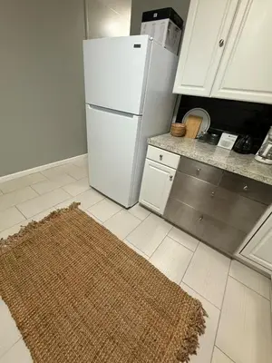 a kitchen with a white refrigerator and a rug at Barnes Avenue near Yale in New Haven