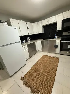 a kitchen with a white refrigerator and a rug at Barnes Avenue near Yale in New Haven