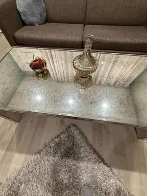 a glass coffee table with two vases on top of it at Barnes Avenue near Yale in New Haven