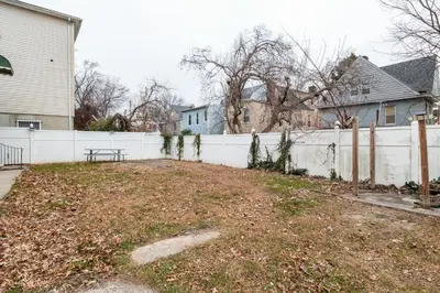 a yard in front of a white fence at Heaven in Newark