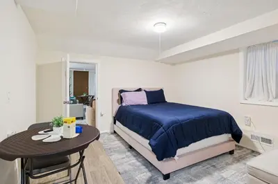a bedroom with a bed and a table in it at Heaven in Newark