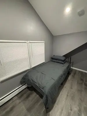 a bedroom with a bed and two windows at The loft 2 bedroom apartment in Newark
