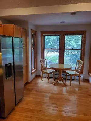 a kitchen with a table and chairs and a refrigerator at Cozy 4bd 4bath Grand Cabin Retreat in Camelback in Tannersville