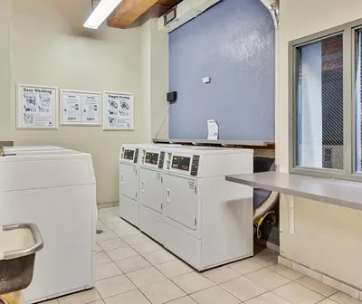a kitchen with white appliances in a room at Landing Stylish 1BD Courtyard in Springfield
