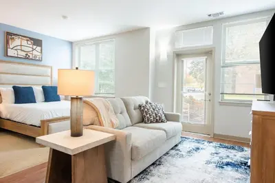a living room with a couch and a bed at Landing Beautiful Studio in South End Stratford in Stratford