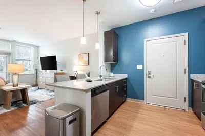 a kitchen with blue walls and a counter top at Landing Beautiful Studio in South End Stratford in Stratford