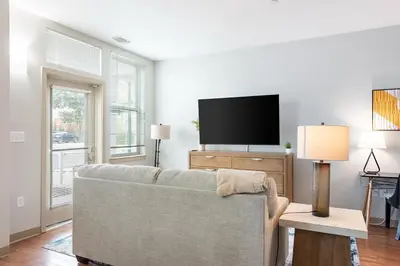 a living room with a couch and a flat screen tv at Landing Beautiful Studio in South End Stratford in Stratford