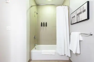 a bathroom with a white tub and a shower at Landing Beautiful Studio in South End Stratford in Stratford