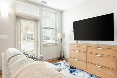 a living room with a flat screen tv on a dresser at Landing Beautiful Studio in South End Stratford in Stratford