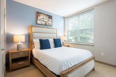 a bedroom with a bed with blue walls and a window at Landing Beautiful Studio in South End Stratford in Stratford