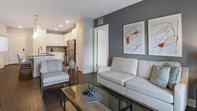 a living room with a couch and a table at Landing Apartments - Park South in Albany