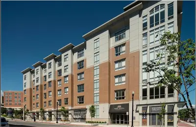 a large brick building on a city street at Landing Apartments - Park South in Albany