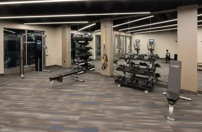 a gym with a lot of equipment in a room at Landing Apartments - Park South in Albany