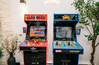 two arcade games sitting next to each other at Creekside Family Dreamland - Hot Tub, Firepit, Arcade in Pocono Summit
