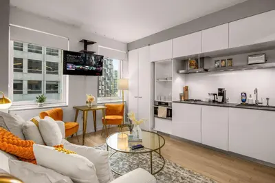 a living room with a couch and a table at Chic NYC Retreat Beside Broadway in New York