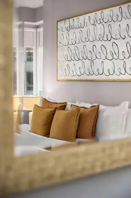 a white couch with brown pillows in a living room at Chic NYC Retreat Beside Broadway in New York