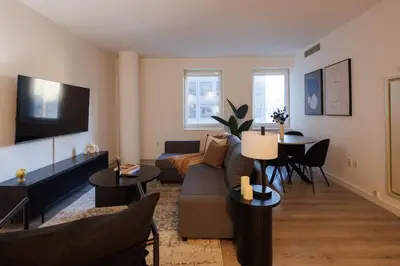 a living room with a couch and a table at Elegant NYC Haven Walk to Broadway in New York