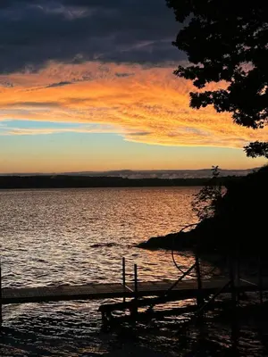 a sunset over a large body of water at Saratoga Lake Boathouse Retreat in Saratoga Springs