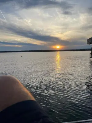a view of the sunset from a boat on a lake at Saratoga Lake Boathouse Retreat in Saratoga Springs