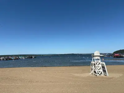 a lifeguard tower sitting on the beach near the water at The Saratoga Beachhouse in Saratoga Springs