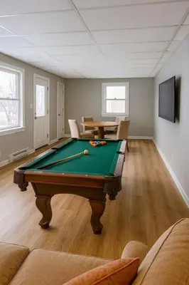 a living room with a pool table in it at The Saratoga Beachhouse in Saratoga Springs