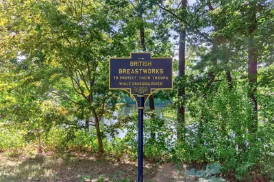a sign in a park with trees in the background at Governors Mansion on the Hudson - Saratoga Riverside Estate in Greenwich