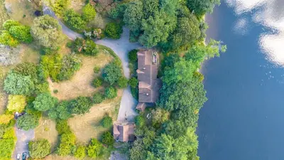 an aerial view of a river with trees and a bridge at Governors Mansion on the Hudson - Saratoga Riverside Estate in Greenwich