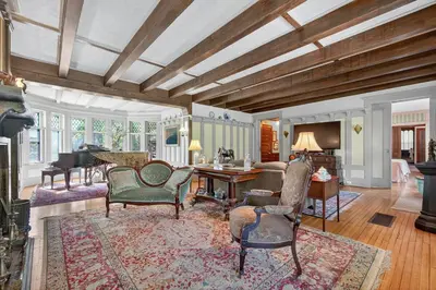 a living room with a table and chairs and a piano at Governors Mansion on the Hudson - Saratoga Riverside Estate in Greenwich
