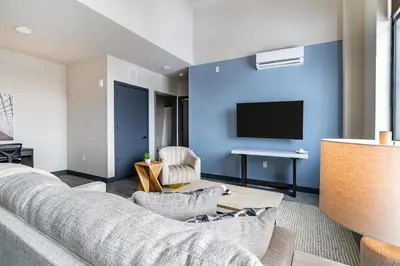 a living room with a couch and a tv at Landing Beautiful 1BD Gym in Hartford