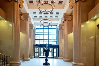 a lobby with a large window and a vase in the middle at Landing Beautiful 1BD Gym in Hartford