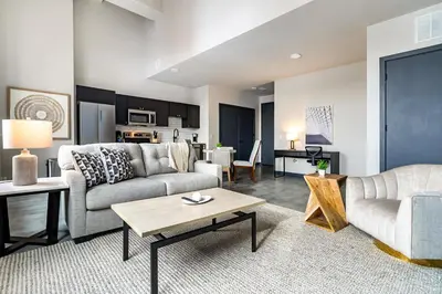 a living room with a couch and a table at Landing Beautiful 1BD Gym in Hartford