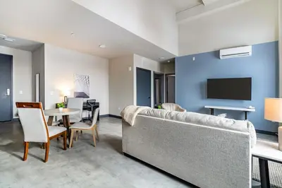 a living room with a couch and a table at Landing Beautiful 1BD Gym in Hartford