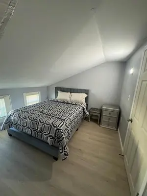 a bedroom with a bed with a black and white comforter at Newly Renovated Single Family Home in Springfield