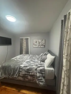 a bedroom with a bed and a television in it at Newly Renovated Single Family Home in Springfield