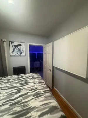 a bedroom with a large bed and a window at Newly Renovated Single Family Home in Springfield