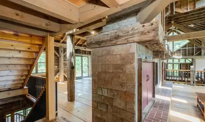 a large room with wooden ceilings and a stone wall at Moonrise Rest A Historic Mohawk Valley Retreat in Schenectady