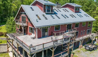 an aerial view of a house with a large deck at Moonrise Rest A Historic Mohawk Valley Retreat in Schenectady