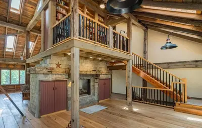 a large room with a staircase and a fireplace at Moonrise Rest A Historic Mohawk Valley Retreat in Schenectady